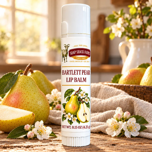 Soap Shack Farms Bartlett Pear Lip Balm in a white 0.15 oz tube on a rustic wooden table with linen in a sunlit farmhouse setting.