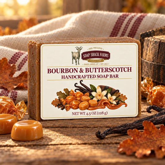 Bourbon and Butterscotch olive oil soap bar on rustic wood with candies, vanilla, oak leaves, barrel wood, and farmhouse linen.