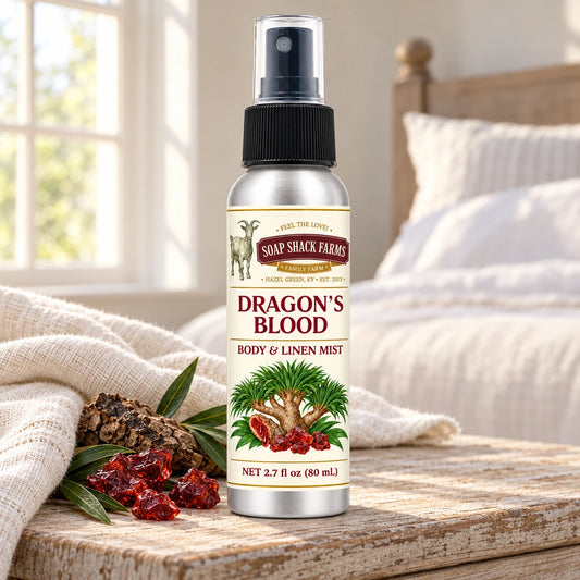 Soap Shack Farms Dragons Blood body and linen mist on a farmhouse bedside table with natural botanicals and linen.