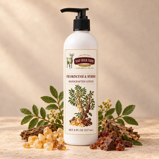 Soap Shack Farms Frankincense and Myrrh Handcrafted Body Lotion surrounded by botanical branches, bark, and golden and amber resins