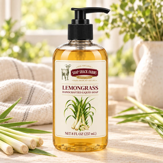 Lemongrass handcrafted liquid soap with fresh lemongrass stalks, green leaves, and farmhouse linen in a sunlit setting.