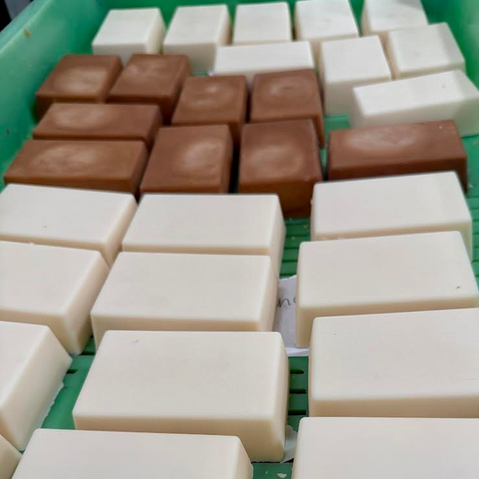 Handcrafted goat milk soap bars curing on a drying rack at Soap Shack Farms, Hazel Green Kentucky