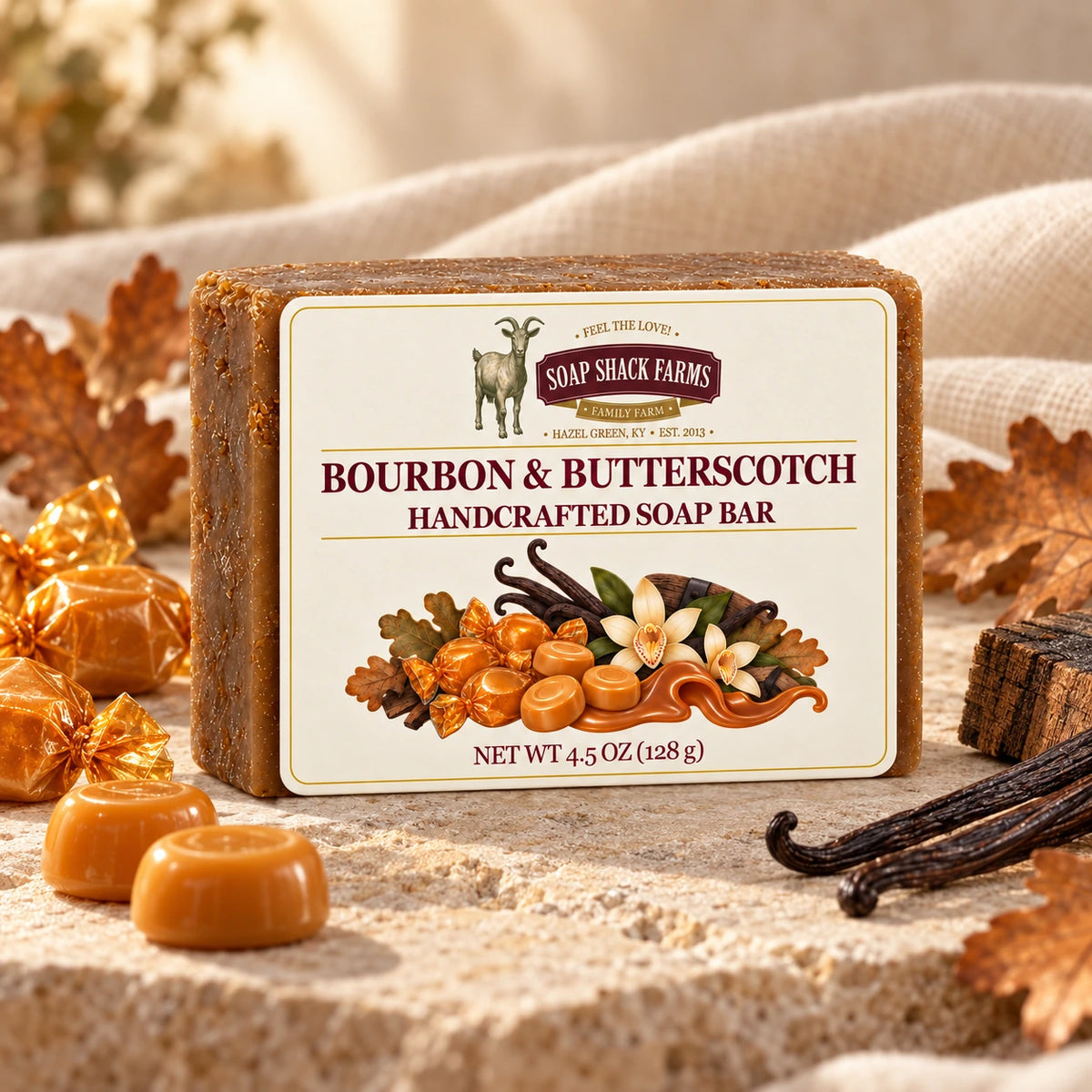 Bourbon and Butterscotch olive oil soap bar on cream stone with candies, vanilla beans, oak leaves, and barrel wood.