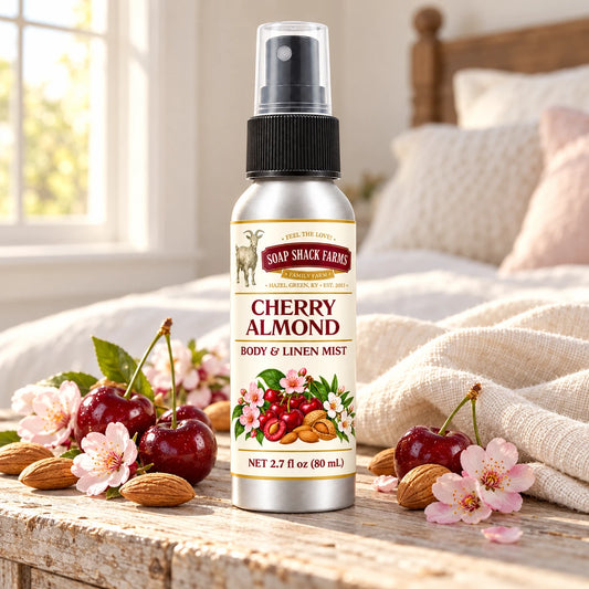 Soap Shack Farms Cherry Almond body and linen mist on a farmhouse bedside table with natural botanicals and linen.