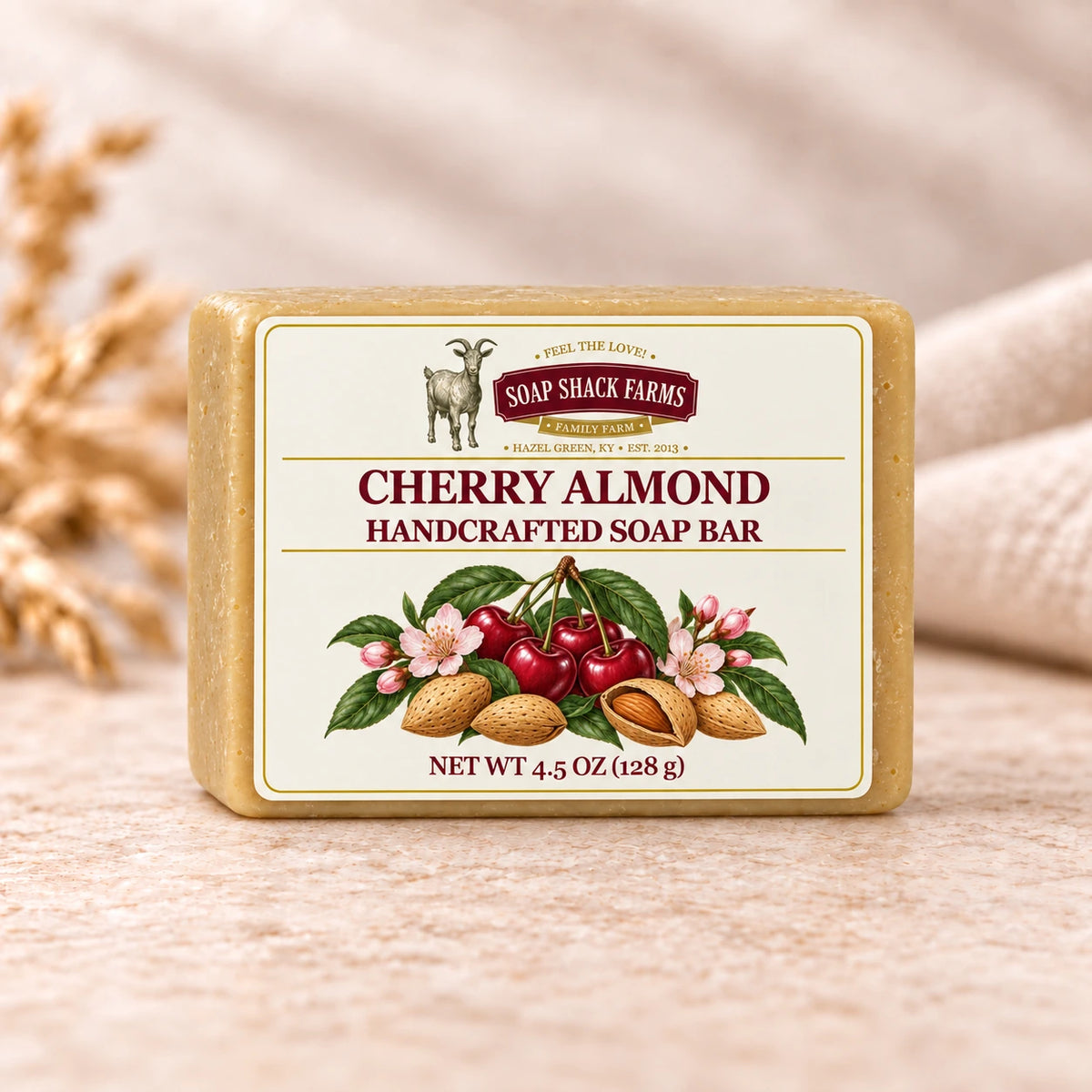 Cherry Almond handcrafted soap bar on warm cream stone with soft linen in a neutral studio setting.