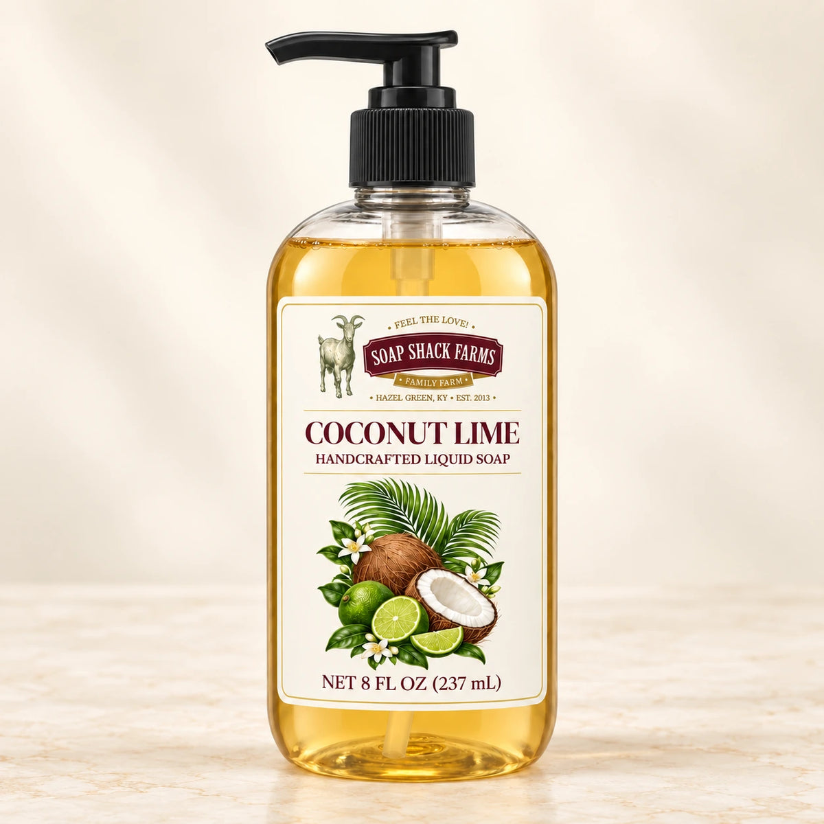 Coconut Lime handcrafted liquid soap in a clear pump bottle on a warm cream studio background.