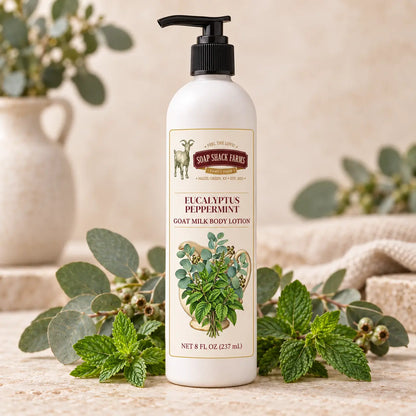 Eucalyptus Peppermint Goat Milk Body Lotion in an 8 oz pump bottle with eucalyptus branches and peppermint leaves
