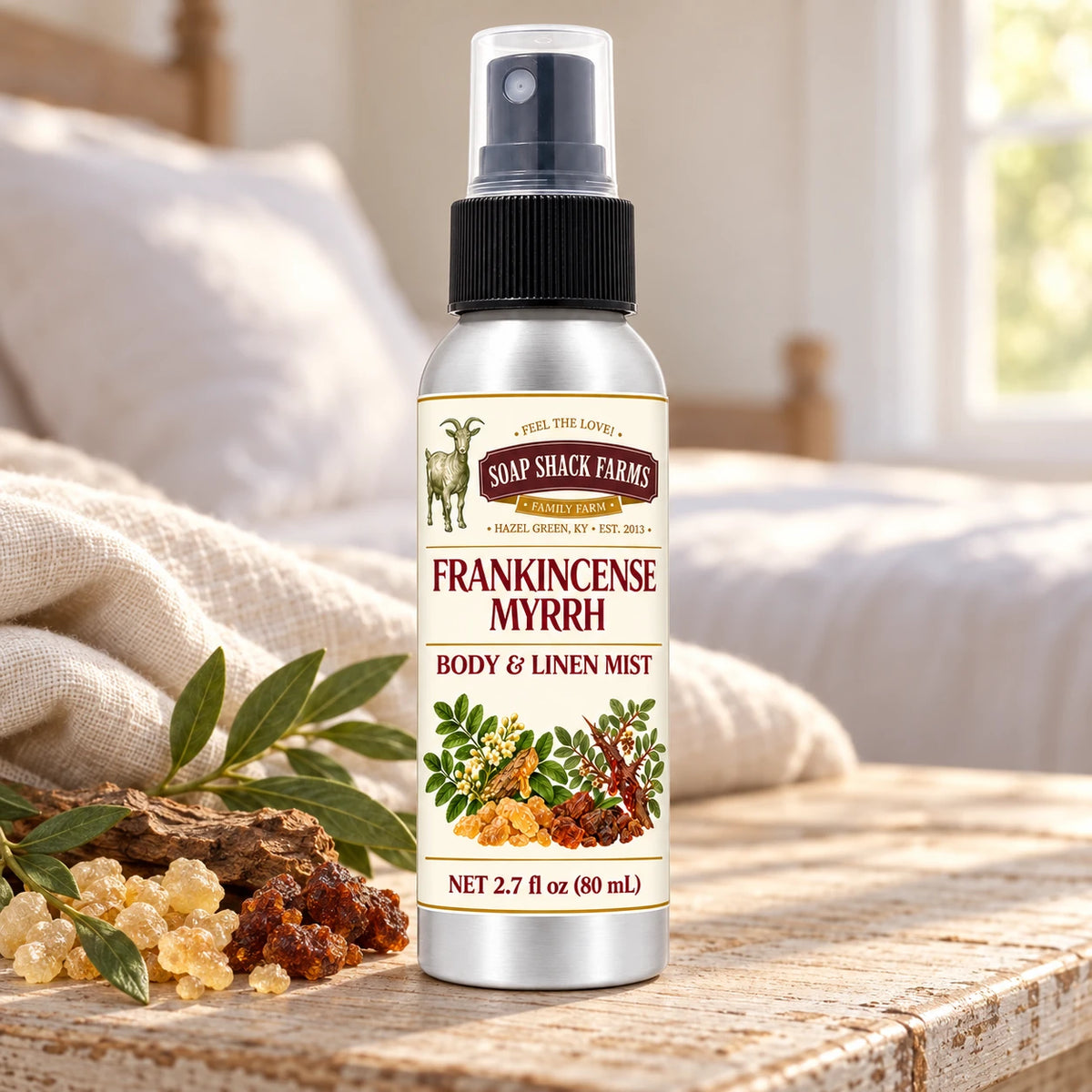 Soap Shack Farms Frankincense Myrrh body and linen mist on a farmhouse bedside table with natural botanicals and linen.