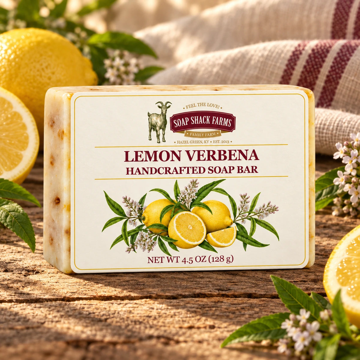 Lemon Verbena olive oil soap bar on rustic wood with lemons, verbena foliage, blossoms, and farmhouse linen.