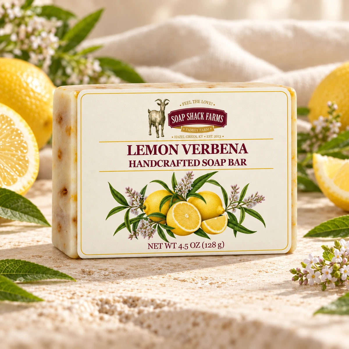 Lemon Verbena olive oil soap bar on warm cream stone with lemons, verbena leaves, and delicate blossoms.