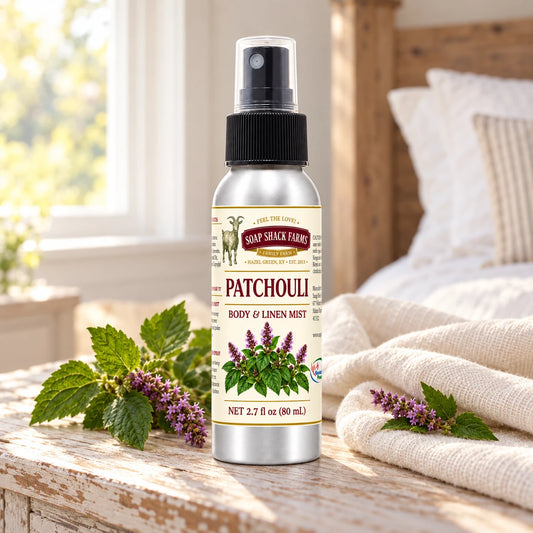 Soap Shack Farms Patchouli body and linen mist on a farmhouse bedside table with natural botanicals and linen.