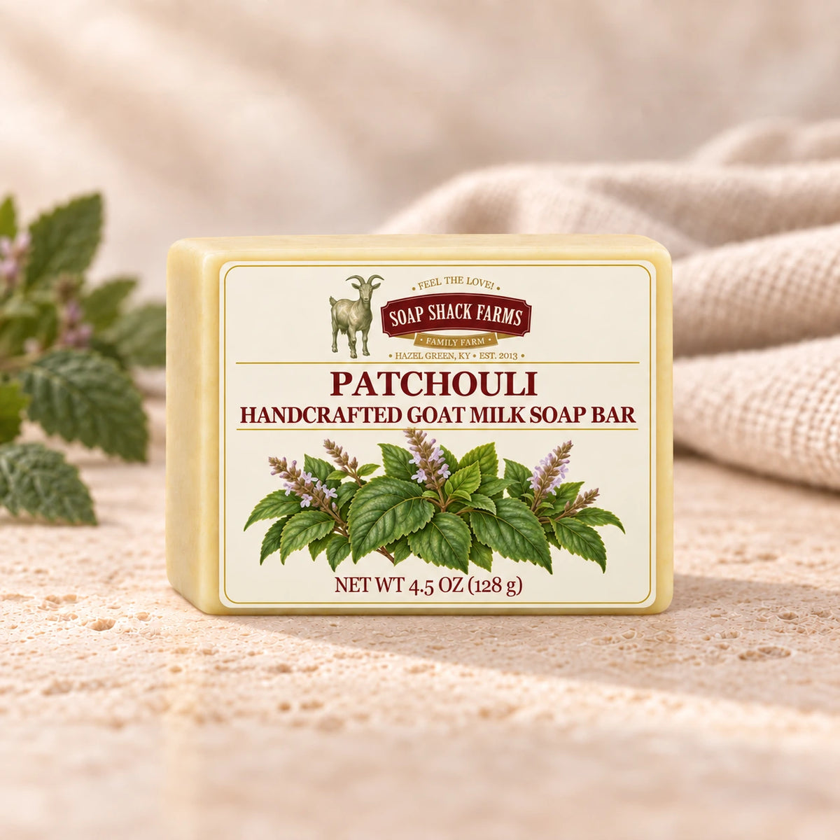 Soap Shack Farms Patchouli goat milk soap displayed on a warm cream surface with soft linen and patchouli leaves.