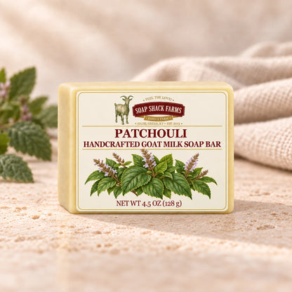 Soap Shack Farms Patchouli goat milk soap displayed on a warm cream surface with soft linen and patchouli leaves.