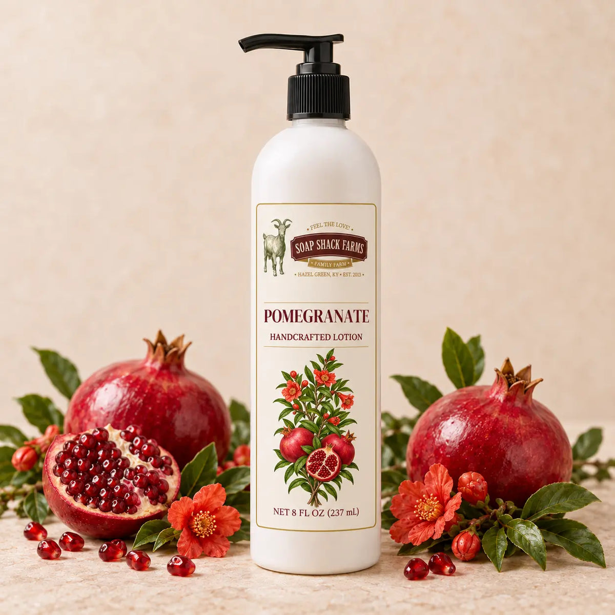 Soap Shack Farms Pomegranate Handcrafted Body Lotion surrounded by ripe pomegranates, ruby seeds, blossoms, and green leaves