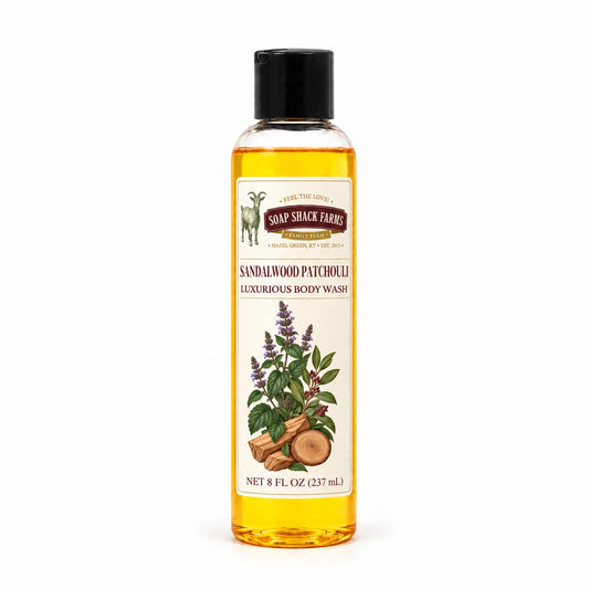 Sandalwood Patchouli luxurious body wash in a slender clear 8 oz bottle with a black disc-top cap on a white background.
