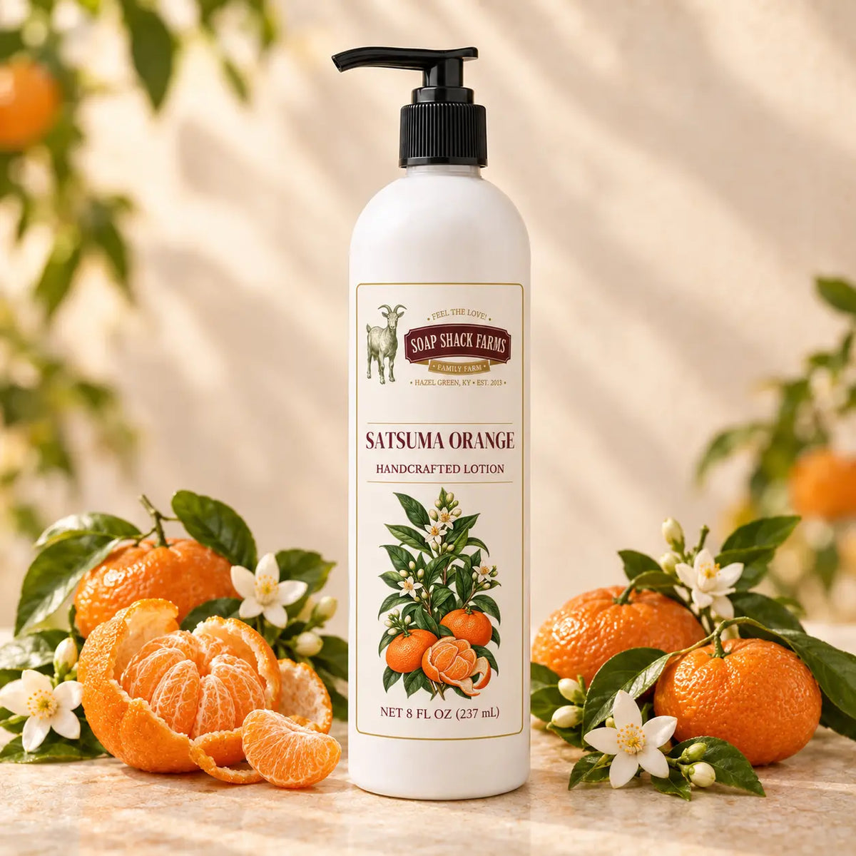 Soap Shack Farms Satsuma Orange Handcrafted Body Lotion surrounded by whole and peeled satsumas, citrus blossoms, and green leaves