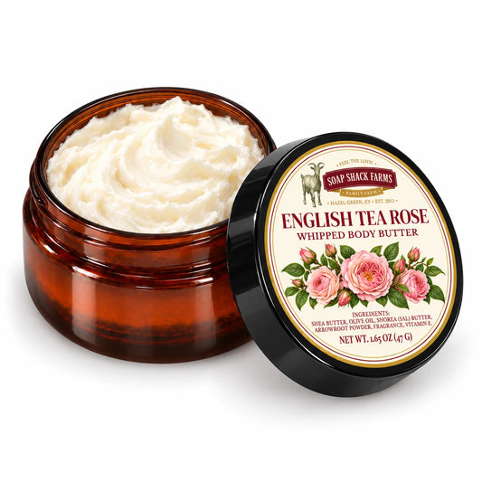 Soap Shack Farms English Tea Rose Whipped Body Butter in an open amber jar showing ivory whipped texture beside its labeled black lid.