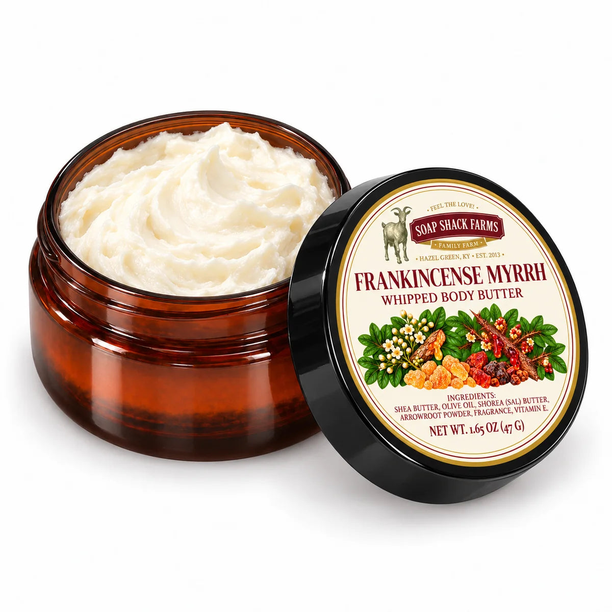 Open amber jar of Soap Shack Farms Frankincense Myrrh Whipped Body Butter showing ivory whipped texture beside its labeled black lid.