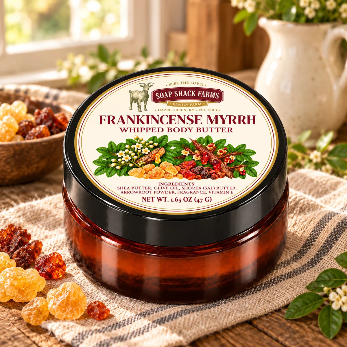 Frankincense Myrrh Whipped Body Butter on rustic wood and linen in a warmly lit farmhouse setting.