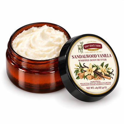 Soap Shack Farms Nag Champa Whipped Body Butter in an open amber jar showing ivory whipped texture beside its labeled black lid.