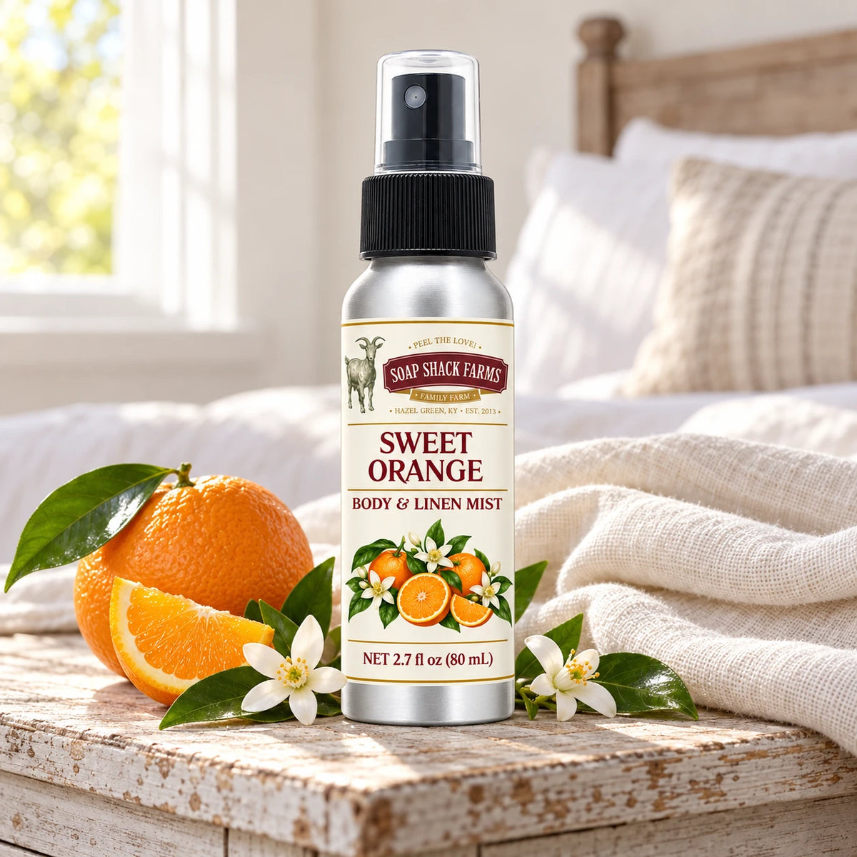 Soap Shack Farms Sweet Orange body and linen mist on a farmhouse bedside table with natural botanicals and linen.