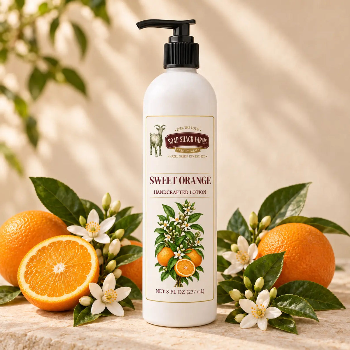 Soap Shack Farms Sweet Orange Handcrafted Body Lotion surrounded by ripe oranges, orange blossoms, and glossy green leaves