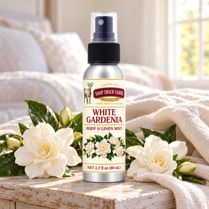 Soap Shack Farms White Gardenia body and linen mist on a farmhouse bedside table with natural gardenia blossoms and linen.