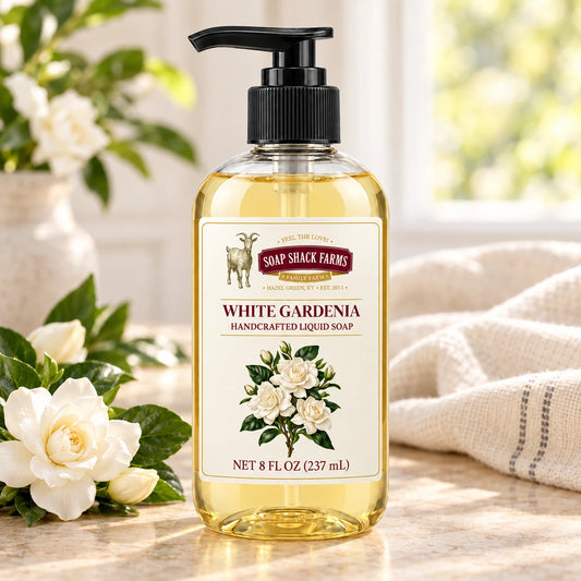 White Gardenia handcrafted liquid soap with white gardenia blooms and farmhouse linen in a sunlit setting.